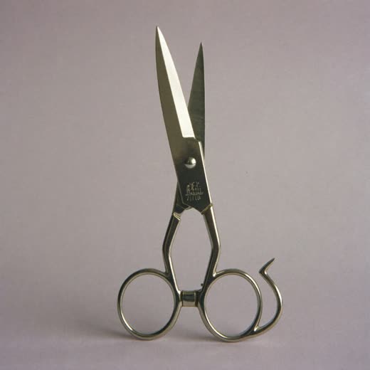 Hair clippers on a plain pastel surface